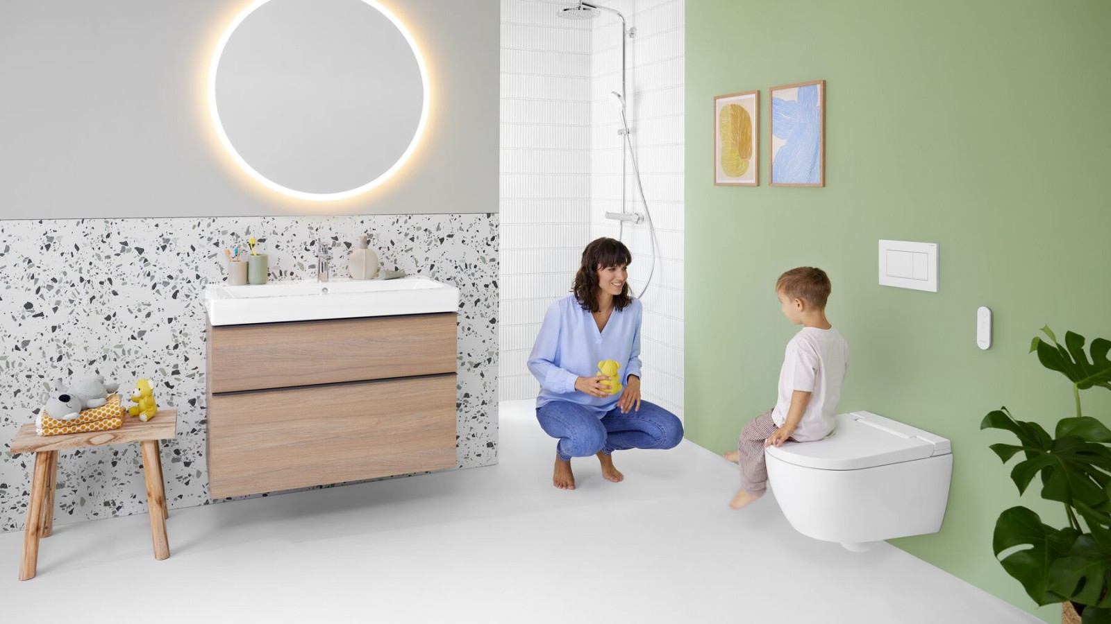 Woman and child in a bathroom with a Geberit AquaClean Alba shower toilet