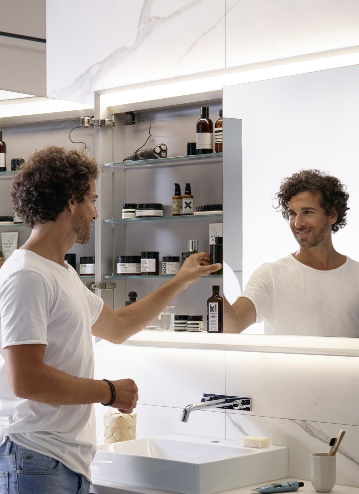 Man in a bathroom with Geberit ONE mirror cabinet
