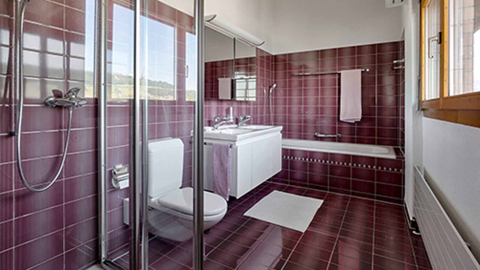 Bathroom before renovation with red tiles