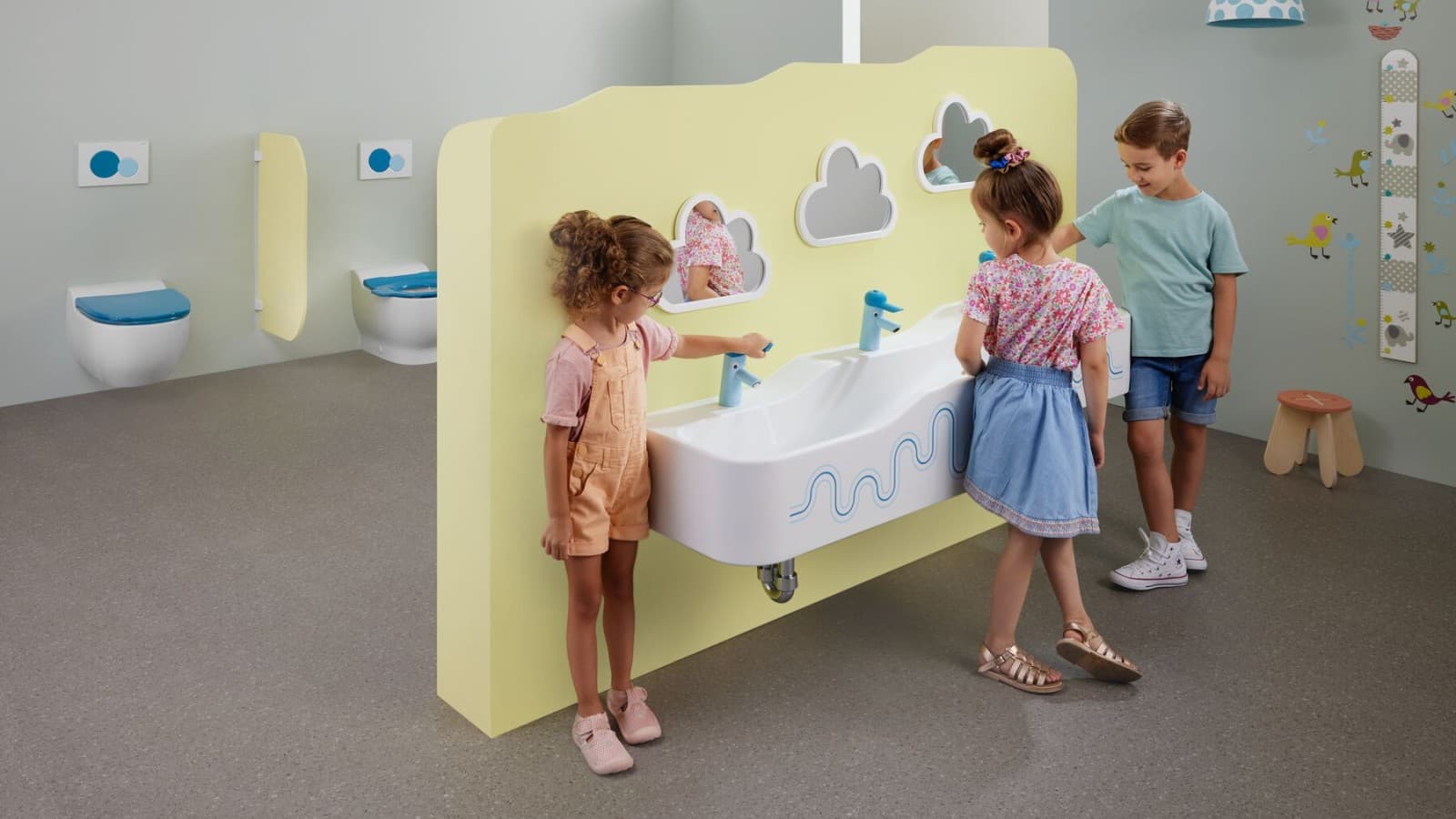 Children play in a sanitary room featuring Geberit Bambini Children play in a sanitary room featuring Geberit Bambini